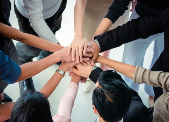 hands of business team on workspace background top view ,